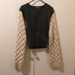Fashionable sweater with Extra long woven sleeves